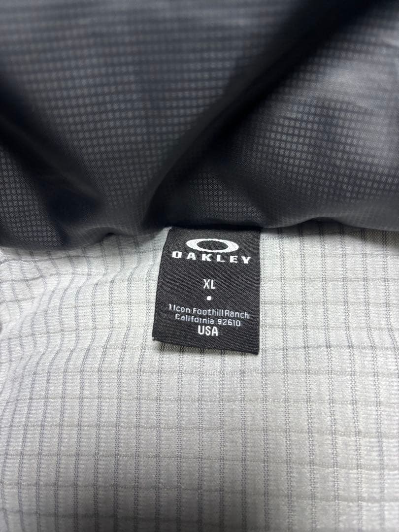 美品OAKLEY オークリー ベンチコート XL ロングコート フード付 ロゴ