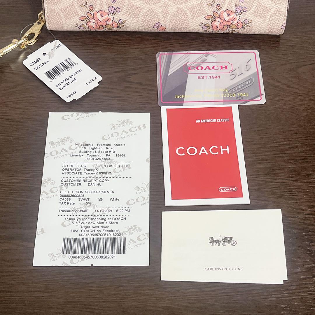 コーチ　 長財布　ベージュ　ストラップ付　花柄　シグネチャー　ラウンドファスナー