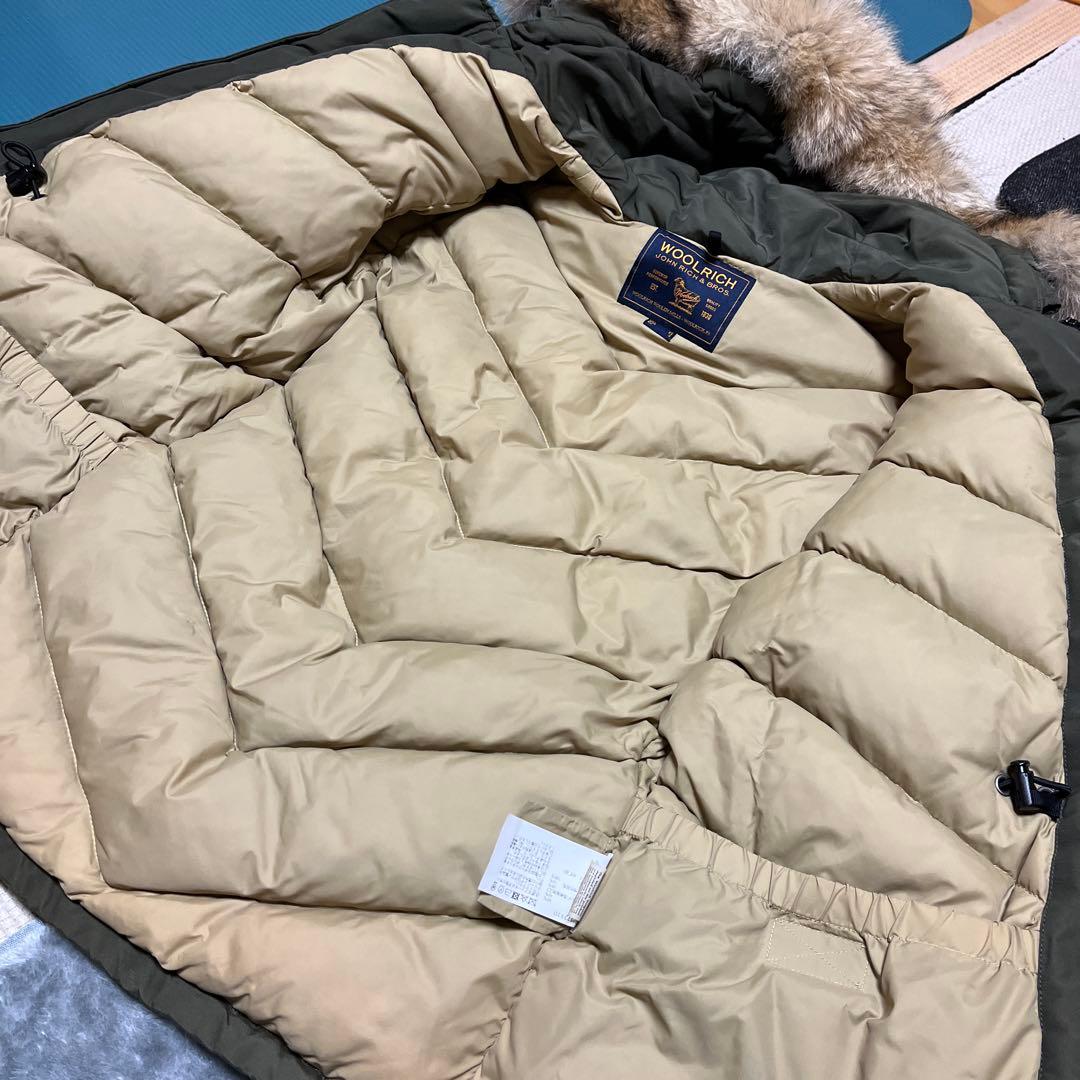 1/31まで。WOOLRICH オリーブ アークティックパーカー