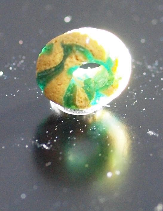 クリアな青緑に鮮やか黄で、回転する輪状モチーフを描くモザイク平玉　前後～6C頃の